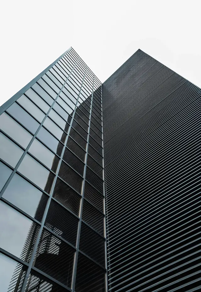 Looking up at the glazed façade of a commercial high-rise